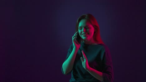 woman talking on phone in neon light