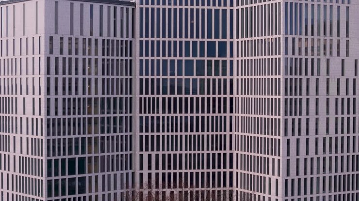 Telephoto aerial riser view of building exterior with lots of windows, abstract