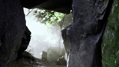 Exploring a mystical cave with sunlight filtering through rocks