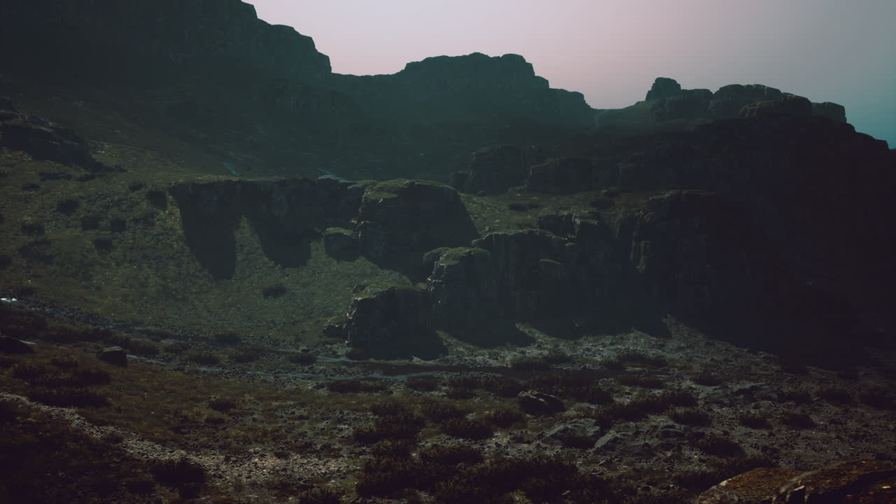 Rocky terrain under muted sunlight in a mountainous region