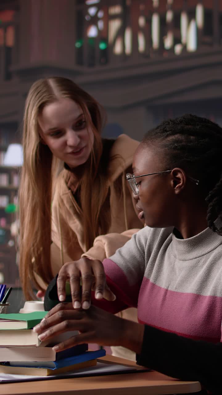 Vertical video person waking up african american girl in the university campus library