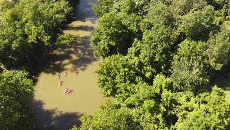 kayakers going down huron river near flat rock in southeast michigan - aerial drone shot