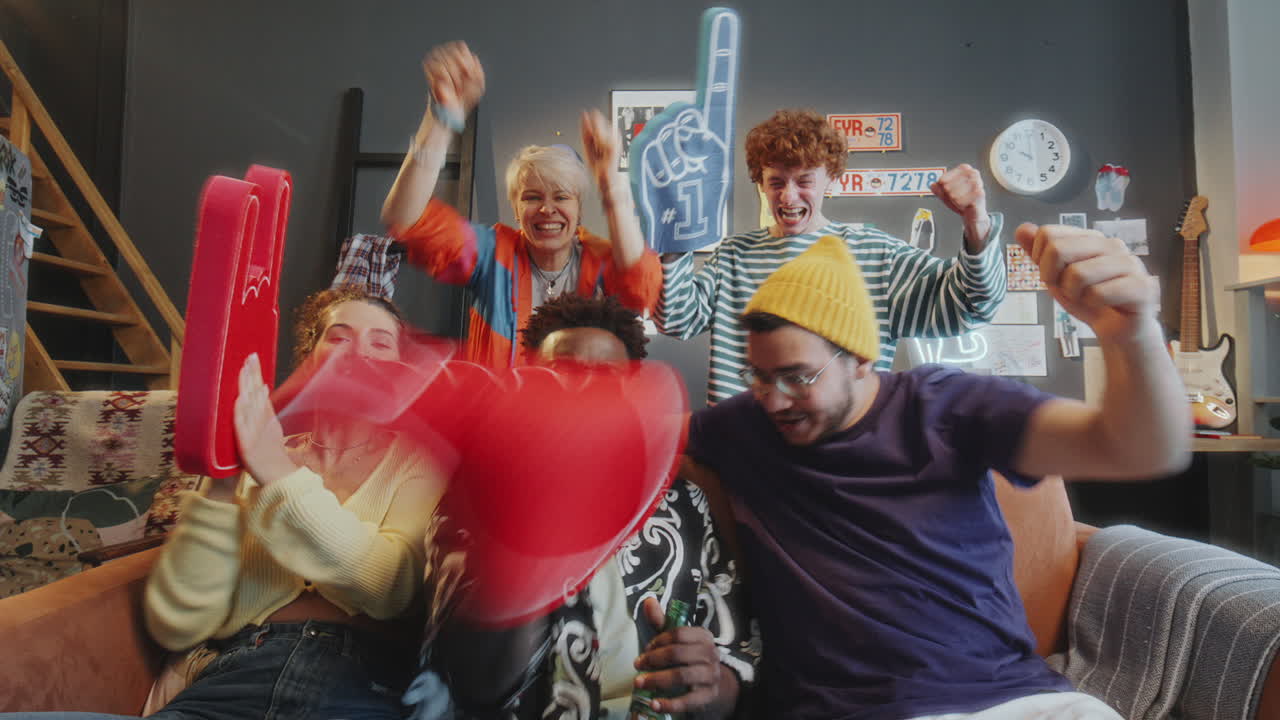 Group of Friends Watching Sports Game on TV and Celebrating with Excitement