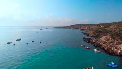 rising aerial drone shot over the coast of konnos bay