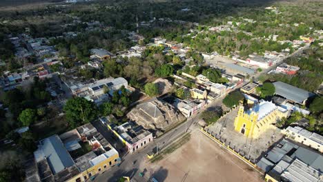 aerial shot of main plaza of acanceh with mayan ruins and church at yucatan mexico