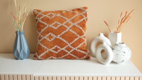 stylish fall decor with orange pillow and vases