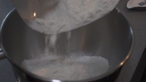 pouring flour into a bowl