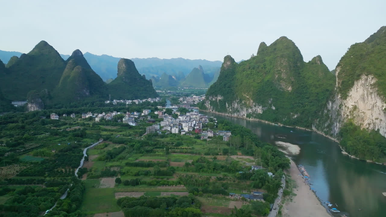 Wide drone shot of the Xingping Ancient Town, sunny, summer evening in China