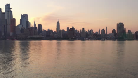 a take off shot from a concrete pier viewing manhattan's westside in the morning