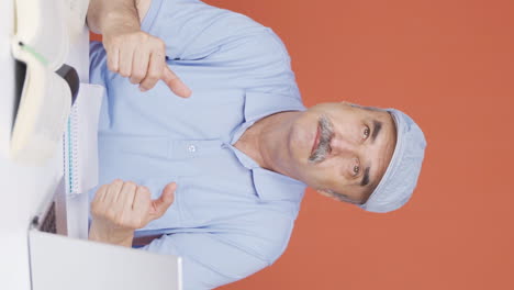 Vertical-video-of-Old-man-with-notebook-thinks-and-takes-notes.