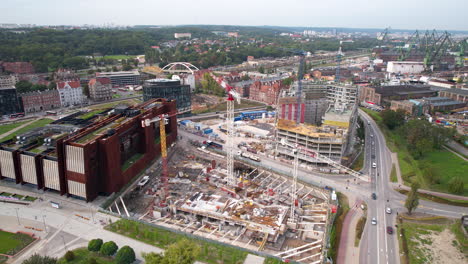 Aerial view of Gdańsk cityscape with construction, roads, and historic architecture