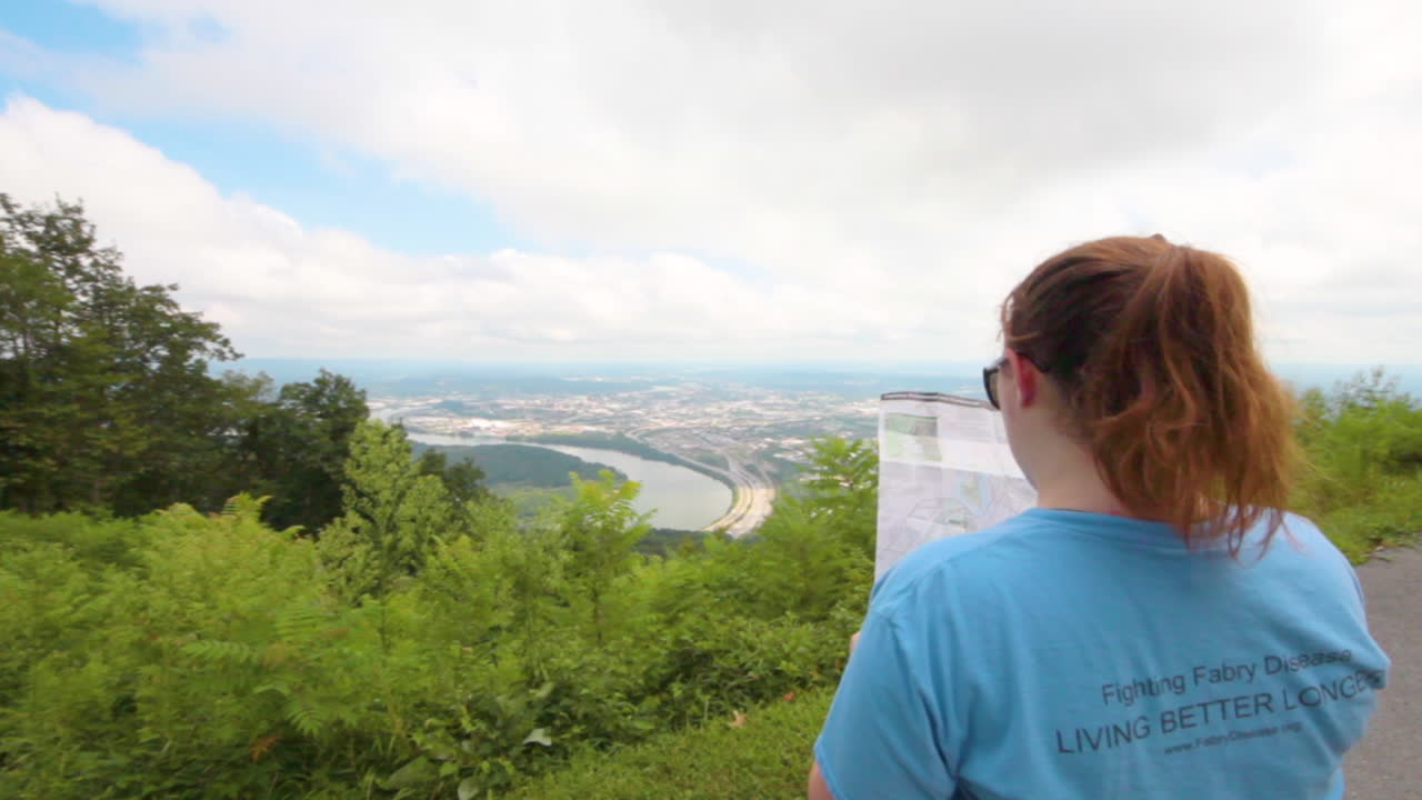 Hiker girl reading a map