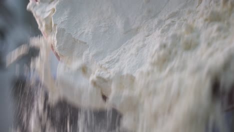 flour being poured into a bowl