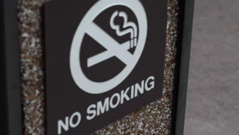 no smoking sign on a trash can in slow motion