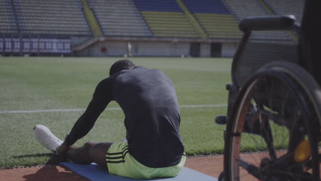 disabled athlete stretching on the field