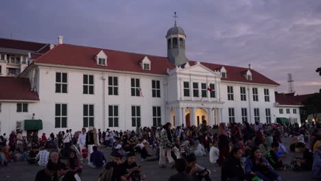 large crowd gathers at jakarta history museum at sunset