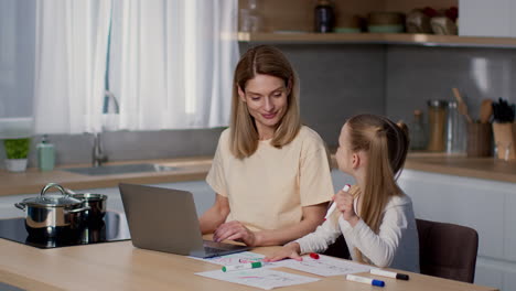 mother and daughter working/drawing at home