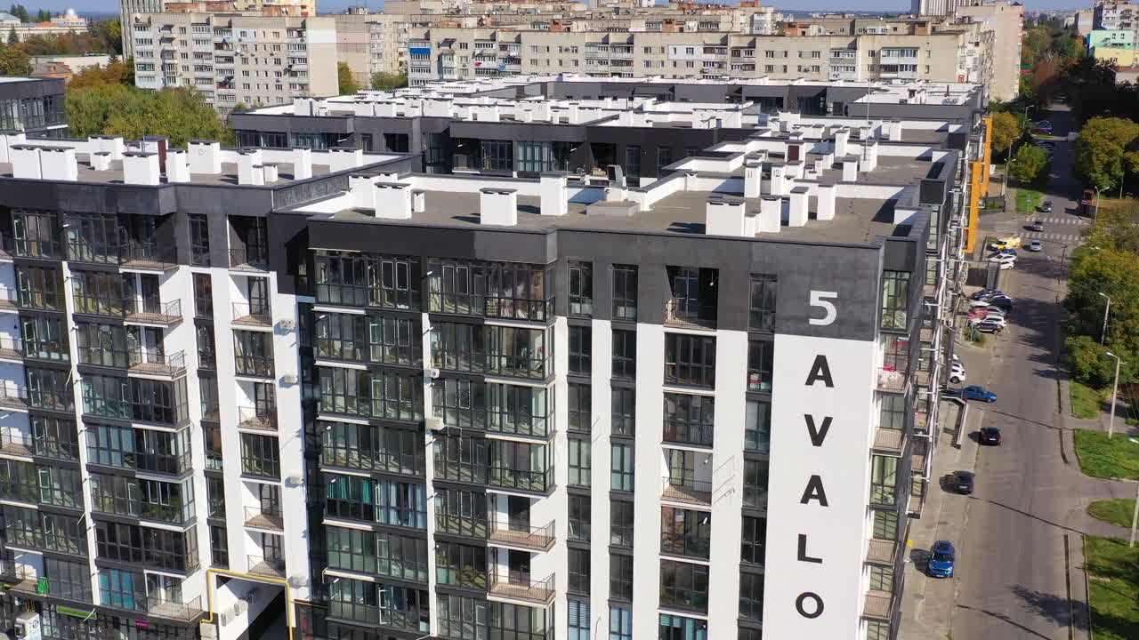 Multi story apartment building. New modern black and white apartment building in the city