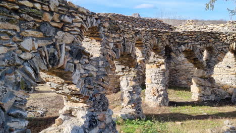 close up of abandoned and damaged stone house in nature