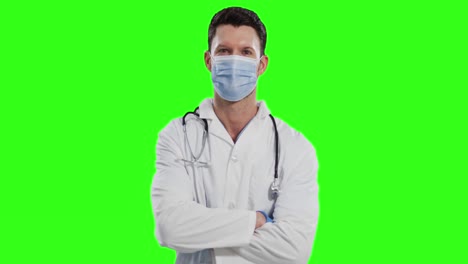 Caucasian-male-doctor-wearing-face-mask-on-green-screen-background