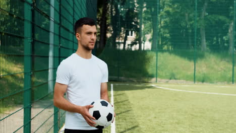 young soccer player doing a throw in on a street football pitch