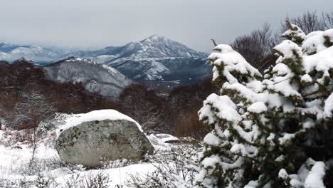 아름다운 저속 겨울 눈 산봉우리 거리 패닝 왼쪽 눈보라