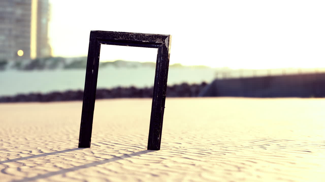 Creative frame stands amid serene sandy landscape at sunset