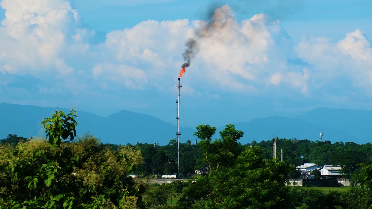 Gas Flare at Industrial Plant with Mountain View