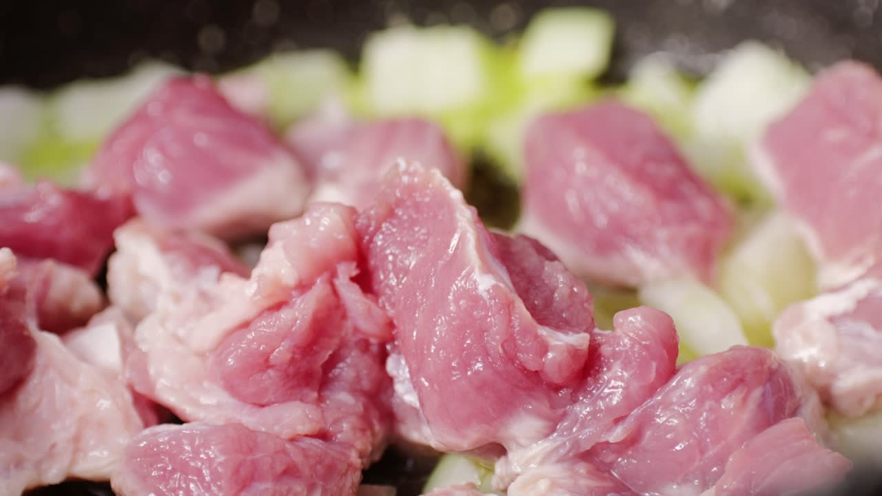 Chicken or pork stew with red and green pepper onion, and spices cooking in a frying pan. Traditional mexican cuisine, tacos preparation, ragout.