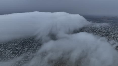 aerial-shot-of-drone-flying-over-city-in-cloudy-day