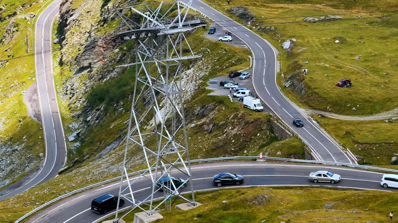 Sharp curve of Transfagarasan road with electricity tower in mountains. Sharp curve of Transfagarasan road with electricity tower in mountains