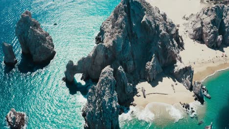 Stunning-top-down-drone-aerial-pan-around-shot-of-rock-formations-in-a-tropical-paradise