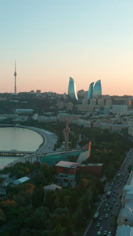 vertical shot of baku city and traffic with the flame towers at dusk