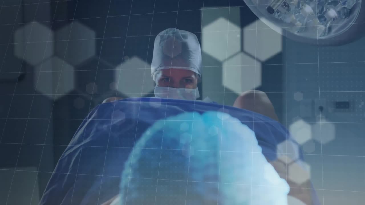 병원 수술실에서 아기를 출산하는 두 인종의 여성 의사에 대한 보케 조명