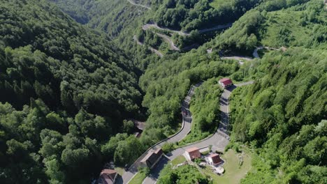 drone zoom in shot of a curvy mountain road in france on a sunny day