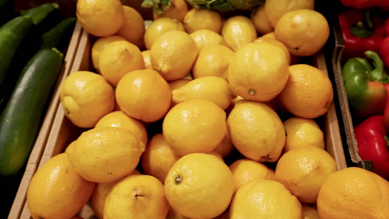 Zucchinis, lemons, and bell peppers displayed