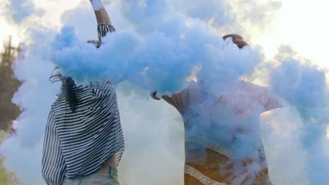 two young women with smoke bomb celebrating the summer festival