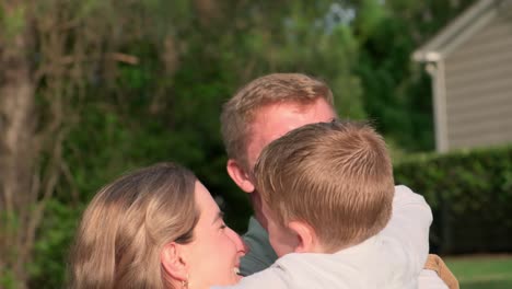 heartwarming video of family hugging in front of house showing love and unity a heartwarming video of a family of four hugging in front of a beautiful house showing love and unity as they stand together creating a touching moment of togetherness