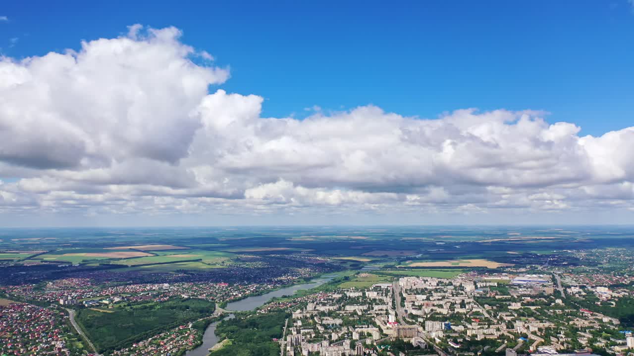 Clouds over the city. Aerial view of fluffy clouds over city