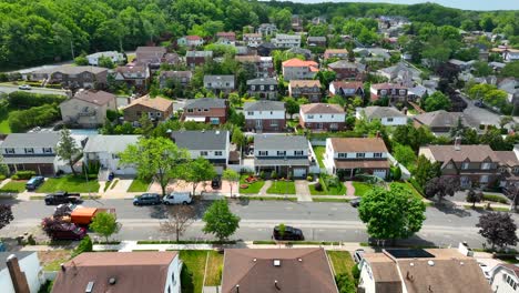 aerial trucking shot beautiful suburb neighborhood in staten island with driving car on road during sunlight - nyc,usa