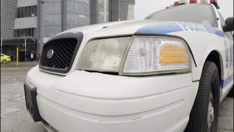 new york city police car in front of a shopping mall