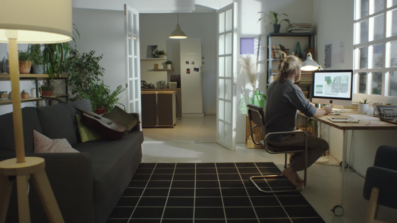 Male Freelancer Working on Computer at Home