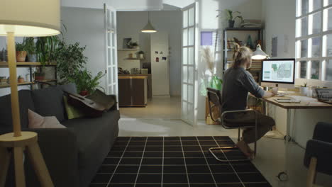 male freelancer working on computer at home