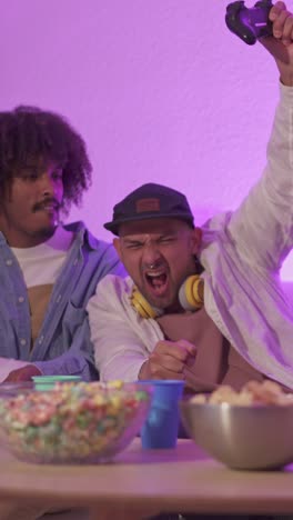 friends playing video games with intense reactions and celebration