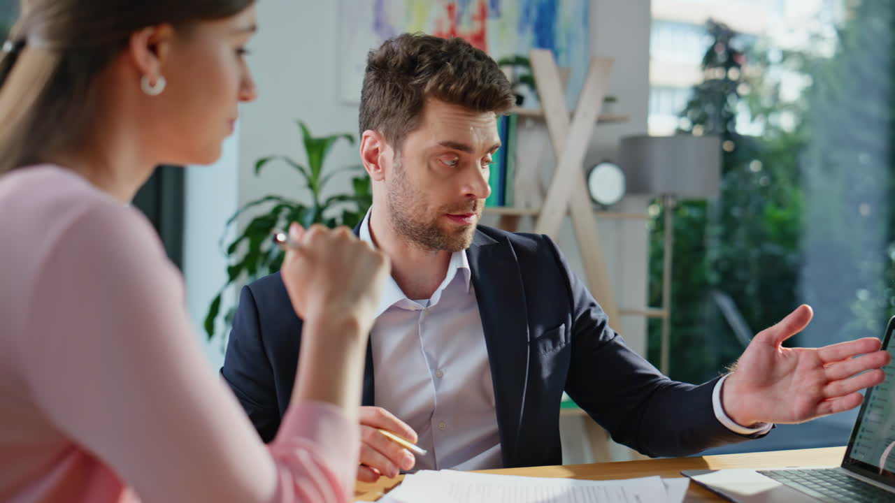 Two colleagues discussing project at agency workplace closeup. Woman talking man