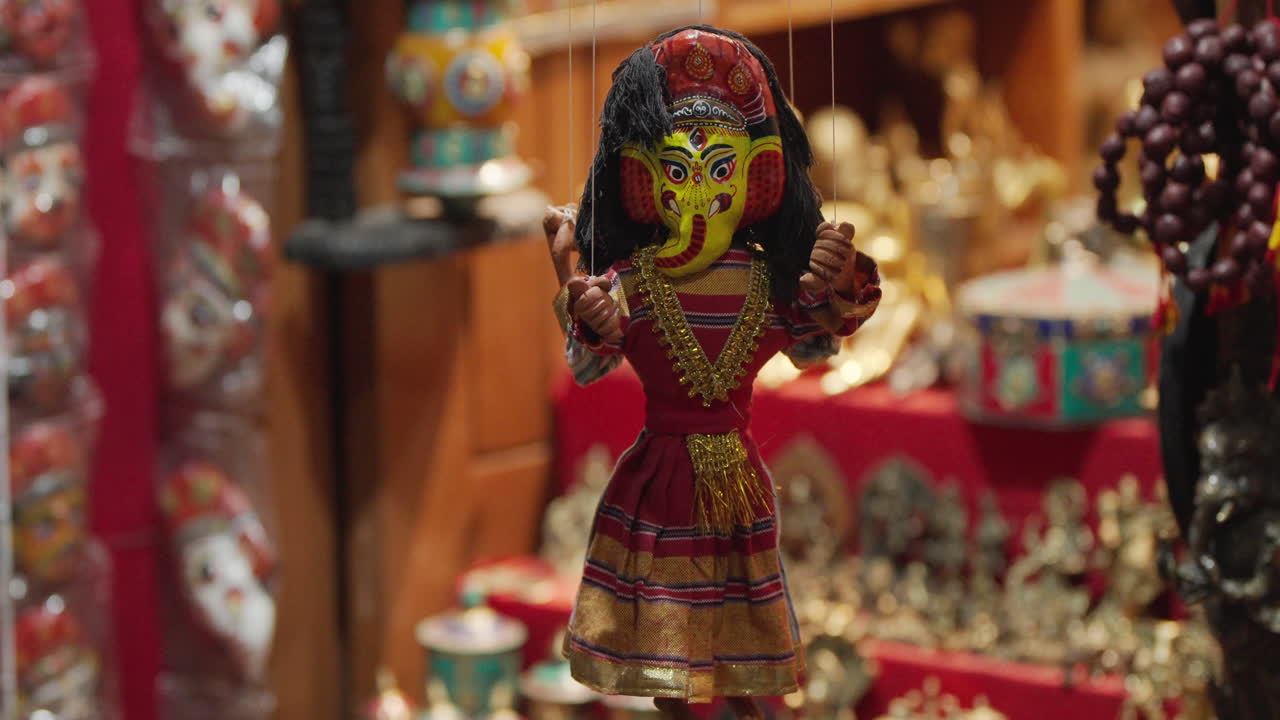 A handmade Nepali puppet dressed in traditional attire hangs at Basantapur Durbar Square, Kathmandu. A colorful symbol of Nepal’s art, culture, and craftsmanship attracting global tourists