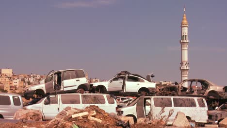 a junkyard stands in front of mosque in the palestinian territories and judean hills of israel