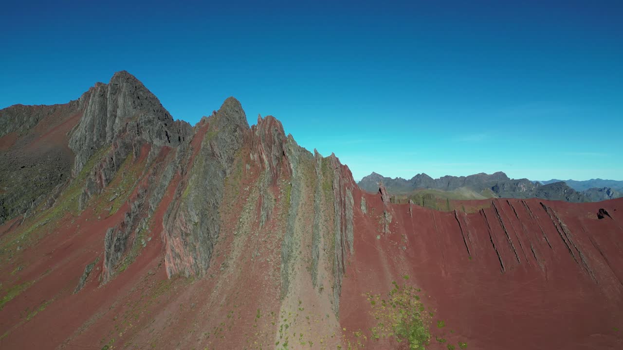 Scenic drone flyover of Peru's Red Valley. Colorful terrain, peaceful atmosphere, and majestic mountain views near Rainbow Mountain
