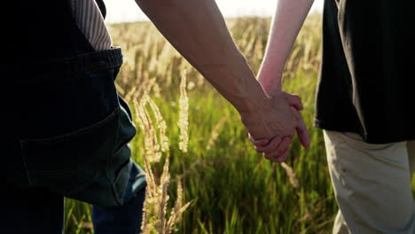 closeup men holding hands