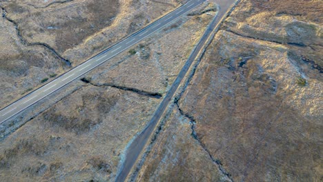 barren landscape with a single road cutting through, glencoe area, golden hour, aerial view